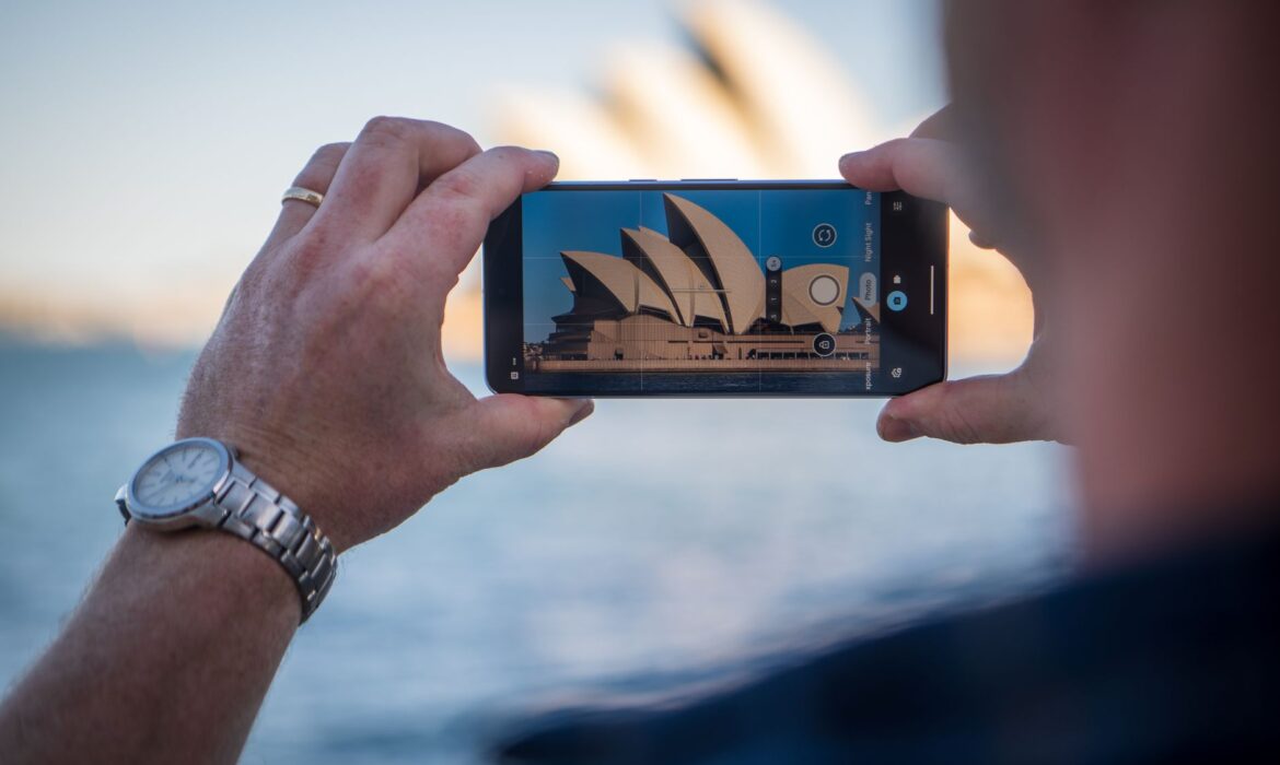 Capturing the iconic Sydney Opera House using a smartphone with a scenic background, adwords sydney