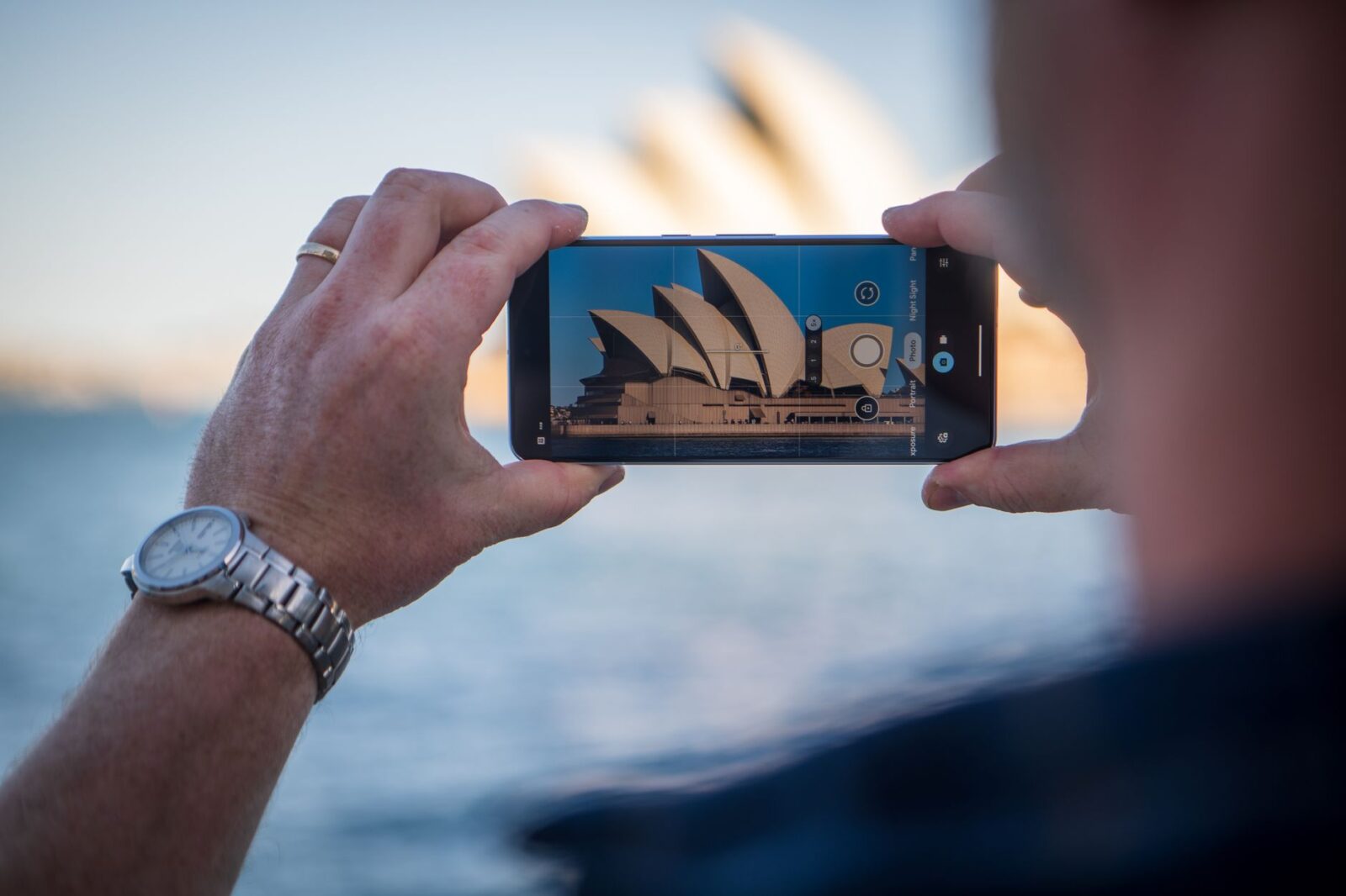 Capturing the iconic Sydney Opera House using a smartphone with a scenic background, adwords sydney
