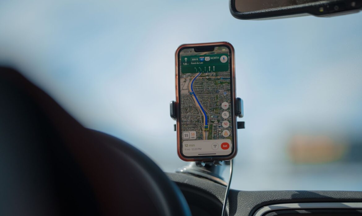 A smartphone with GPS navigation app mounted on a car dashboard during a road trip, cws marketing centennial square