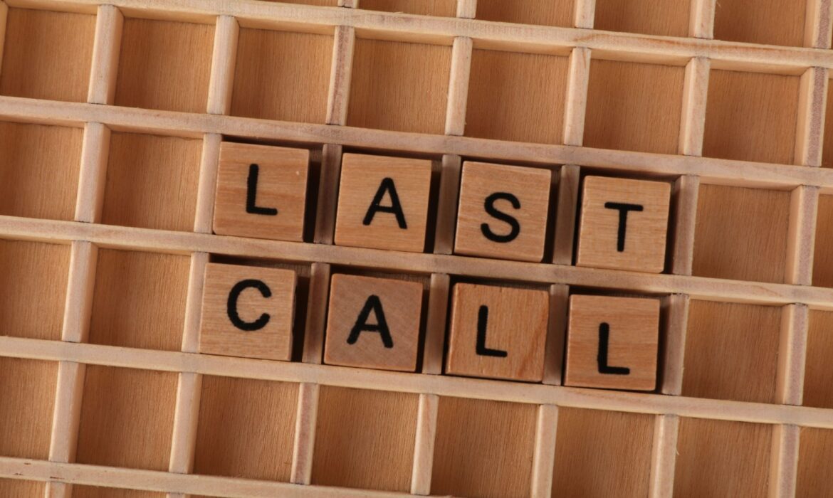 Wooden letter tiles forming the phrase 'Last Call' on a wooden background.
